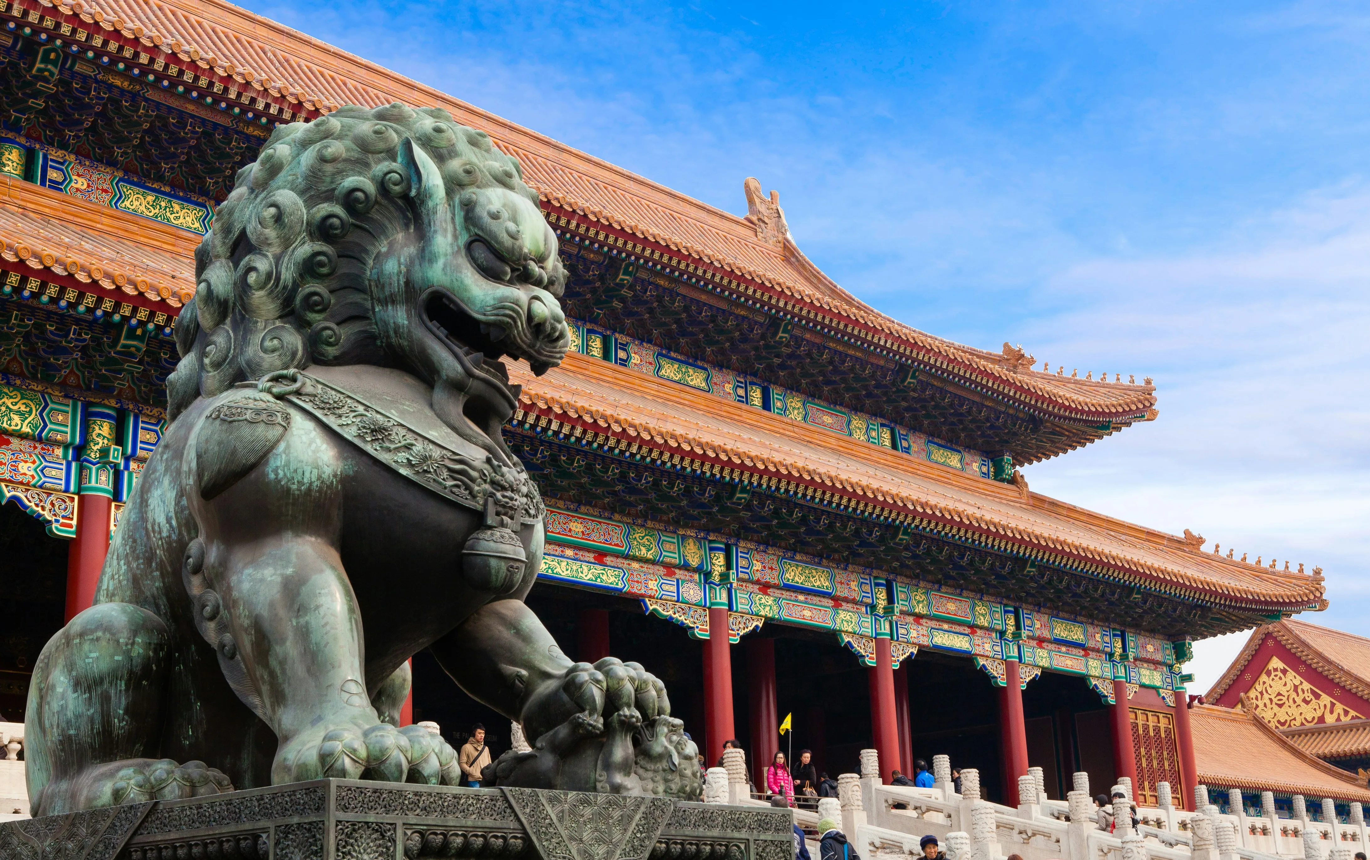 Lion de bronze devant les toits vernissés de la Cité interdite, à Pékin